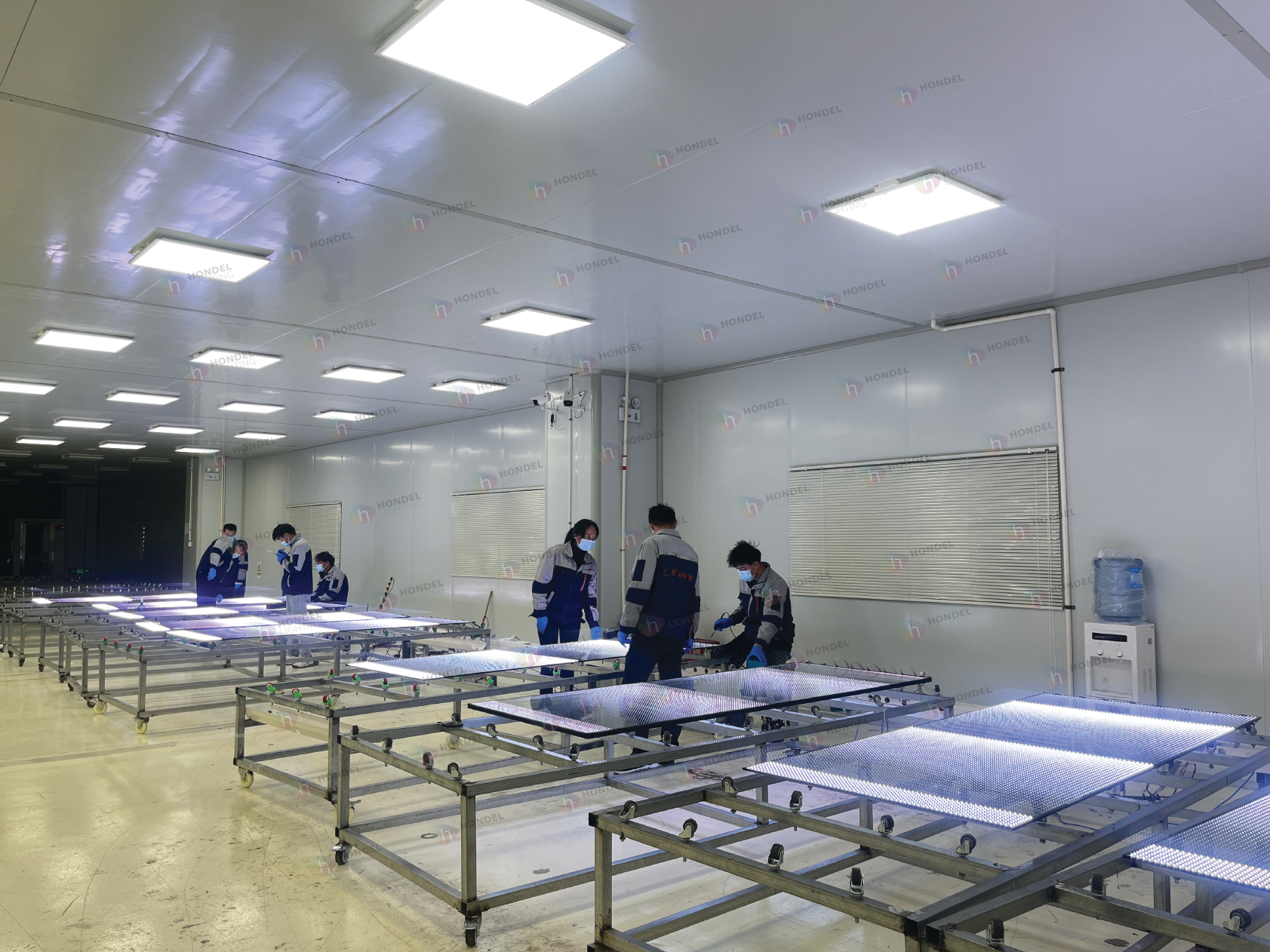 Hondel Lighting manufacturing floor showing multiple transparent LED glass screens undergoing aging tests