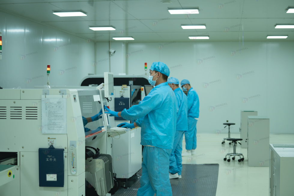 Workers monitoring the continuous production line for high-brightness media facade screens